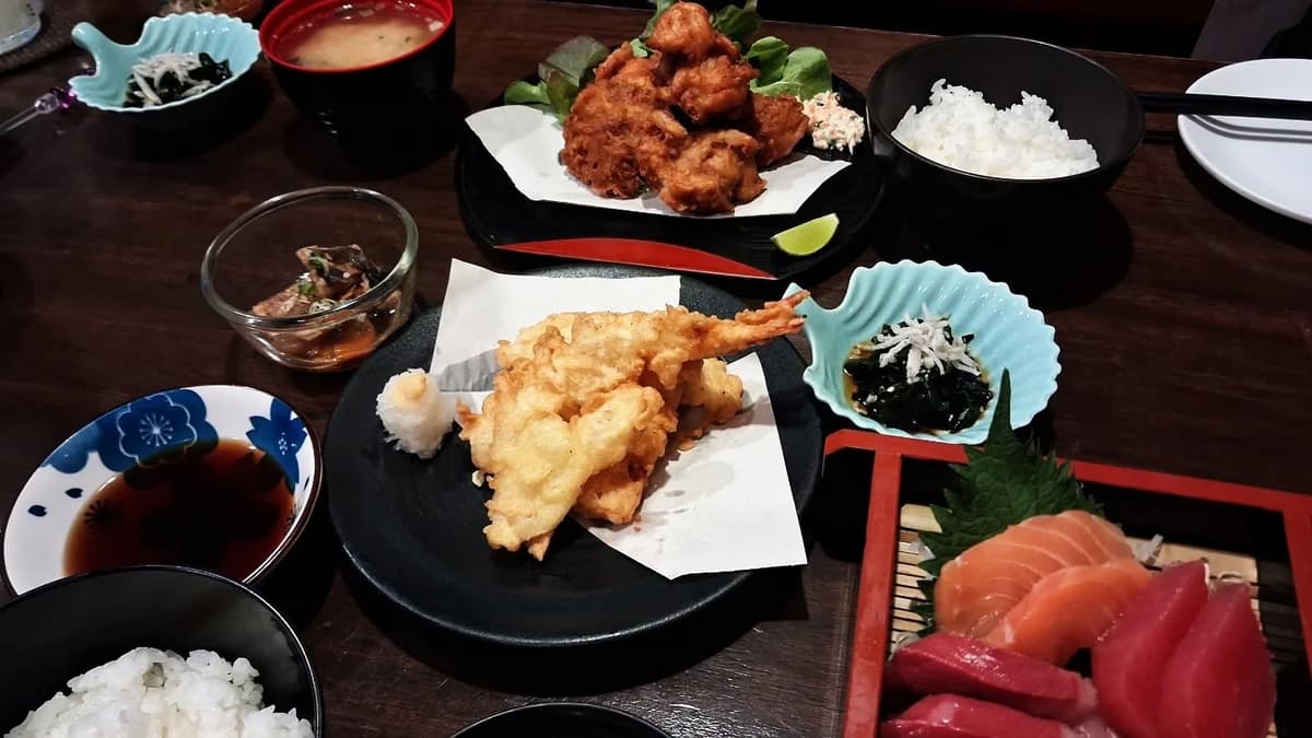 田中水産の刺身や天ぷら、唐揚げが並ぶ和食の食卓