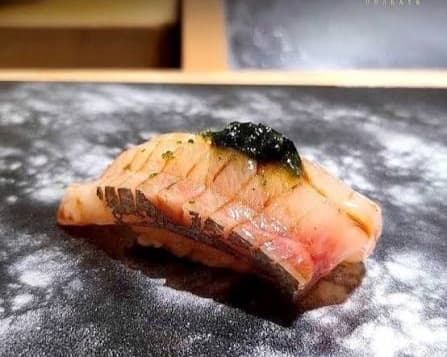 白身魚の握り寿司を黒い器に盛り付けた一品
