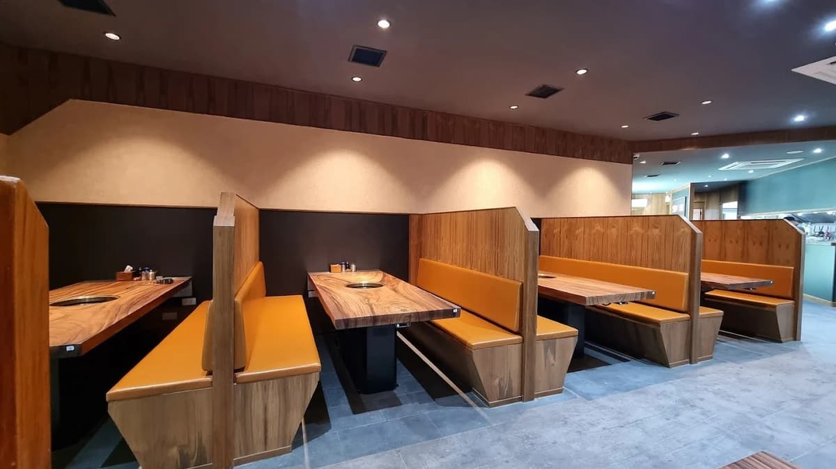 木目調のテーブルと仕切り付きボックス席が並ぶ焼肉広島の店内