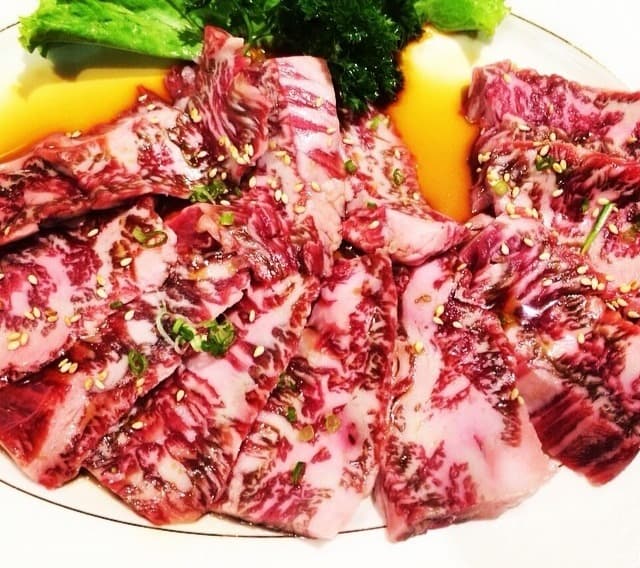 タレに漬けた霜降り牛肉を皿いっぱいに盛り付けた焼肉メニュー